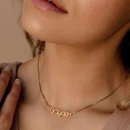 Close-up of a model wearing the Personalized Callie Signature Necklace in silver, highlighting the elegant engraved signature.