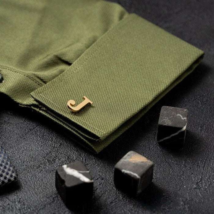 Man's shirt cuff adorned with an Eraya Jewel Golden Customized Single Initial Cufflink, featuring a distinct and stylish personalized initial
