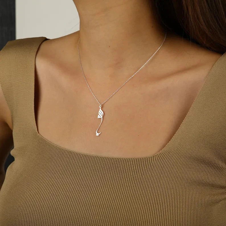 Model wearing the Noor Allah Pendant, emphasizing its modern design and spiritual elegance.