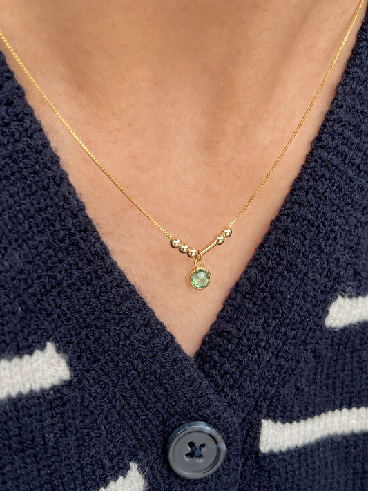 Personalized Birthstone Morse Code Necklace in 22K gold featuring a green birthstone charm, minimalist 4 mm Morse code beads, and an adjustable chain by Eraya Jewel.