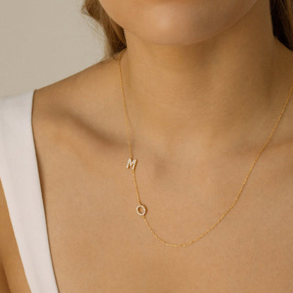 Personalized couple initial necklace with CZ M and O initials worn on a model
