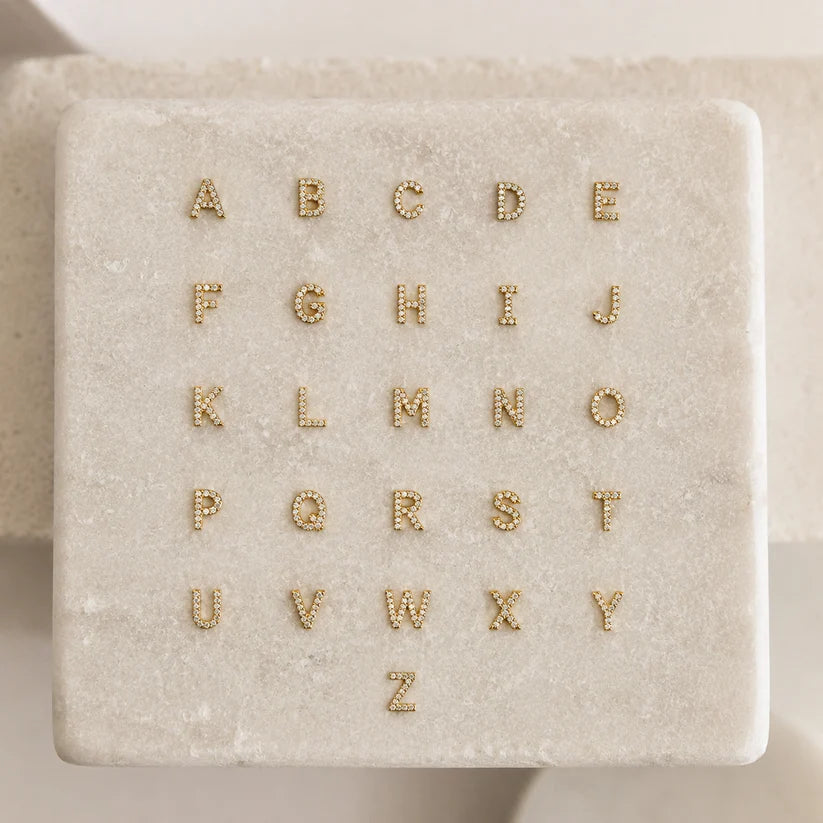 Alphabet options for the Personalized Diamond Initial Necklace featuring 7mm pavé CZ initials A-Z in 22K Gold Finish. Customize your necklace with any letter.