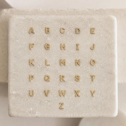 Alphabet options for the Personalized Diamond Initial Necklace featuring 7mm pavé CZ initials A-Z in 22K Gold Finish. Customize your necklace with any letter.
