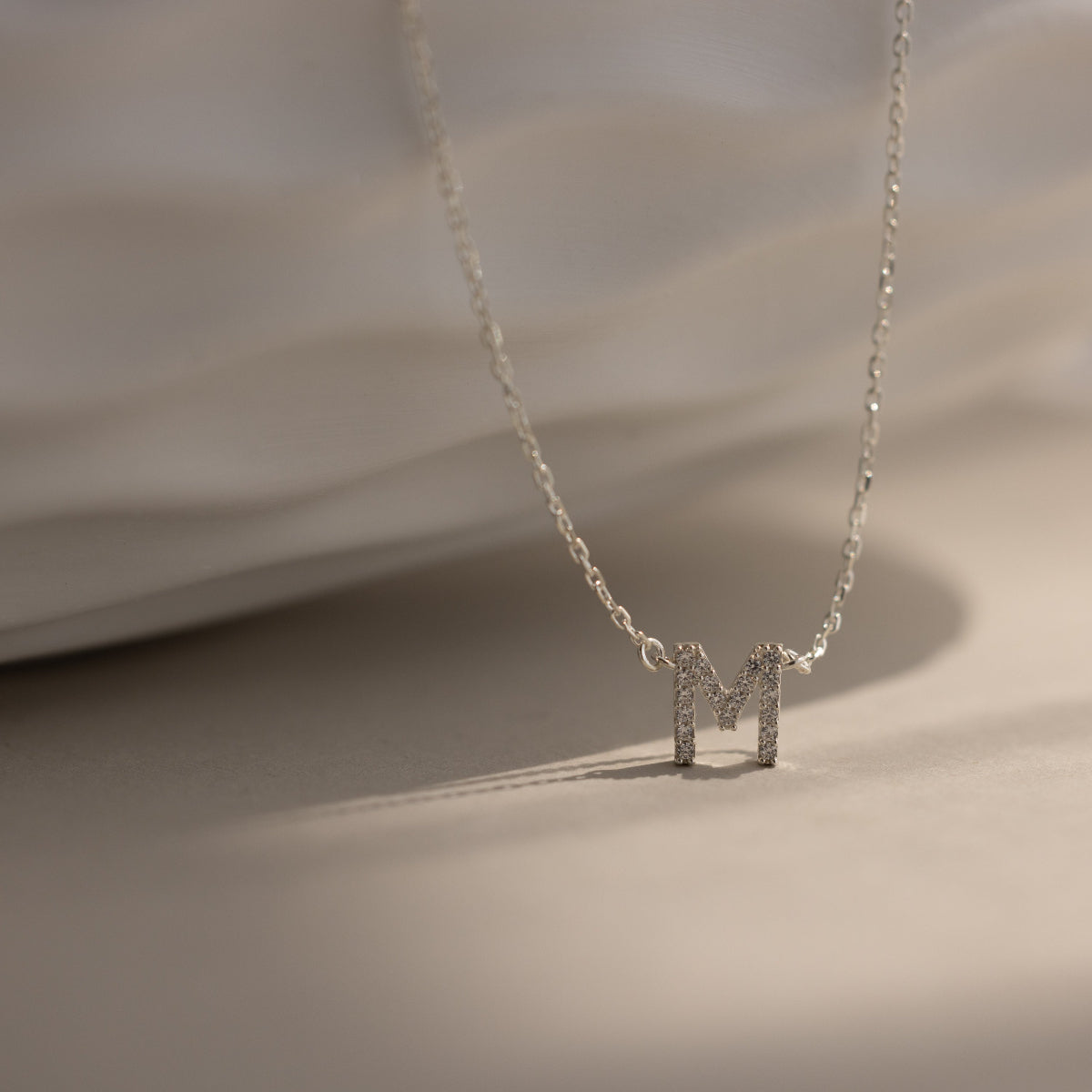 Personalized Diamond Initial Necklace with 7mm pavé CZ letter M in Silver Finish on an anti-tarnish chain.