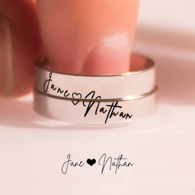 Couple's hands together wearing the matching Custom Handwriting Cross Couple Ring Set.