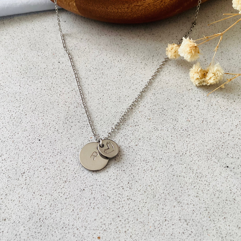Heart and initial pendant in 925 sterling silver on white background