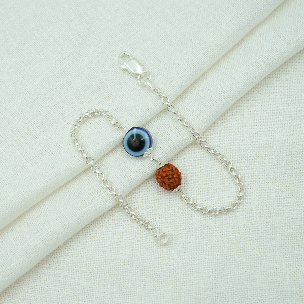 Flat lay image of Rudraksha evil eye silver bracelet with 925 silver chain, highlighting the handcrafted spiritual jewelry design