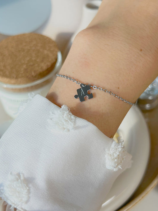 Model wearing silver puzzle initial bracelet 