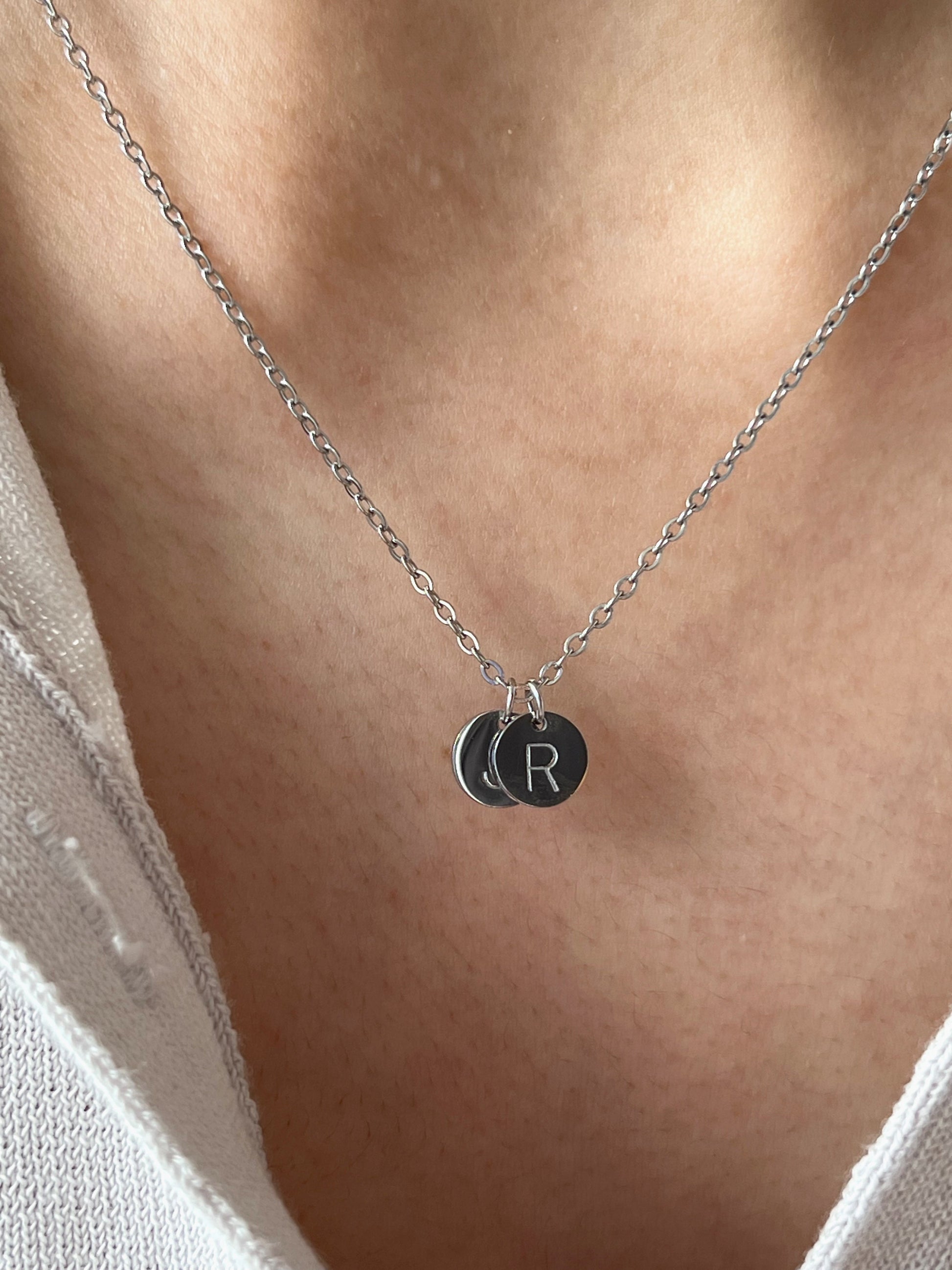 Model wearing silver initial coin pendant 