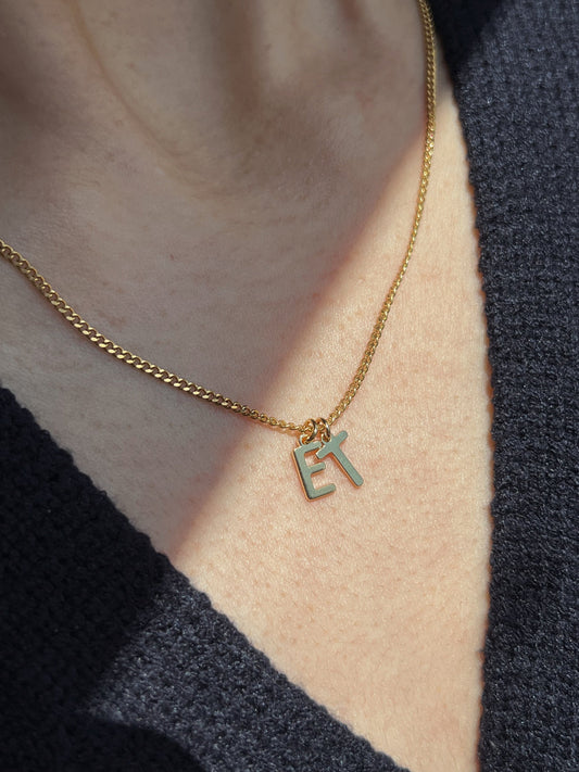 Model wearing gold initial alphabet pendant necklace