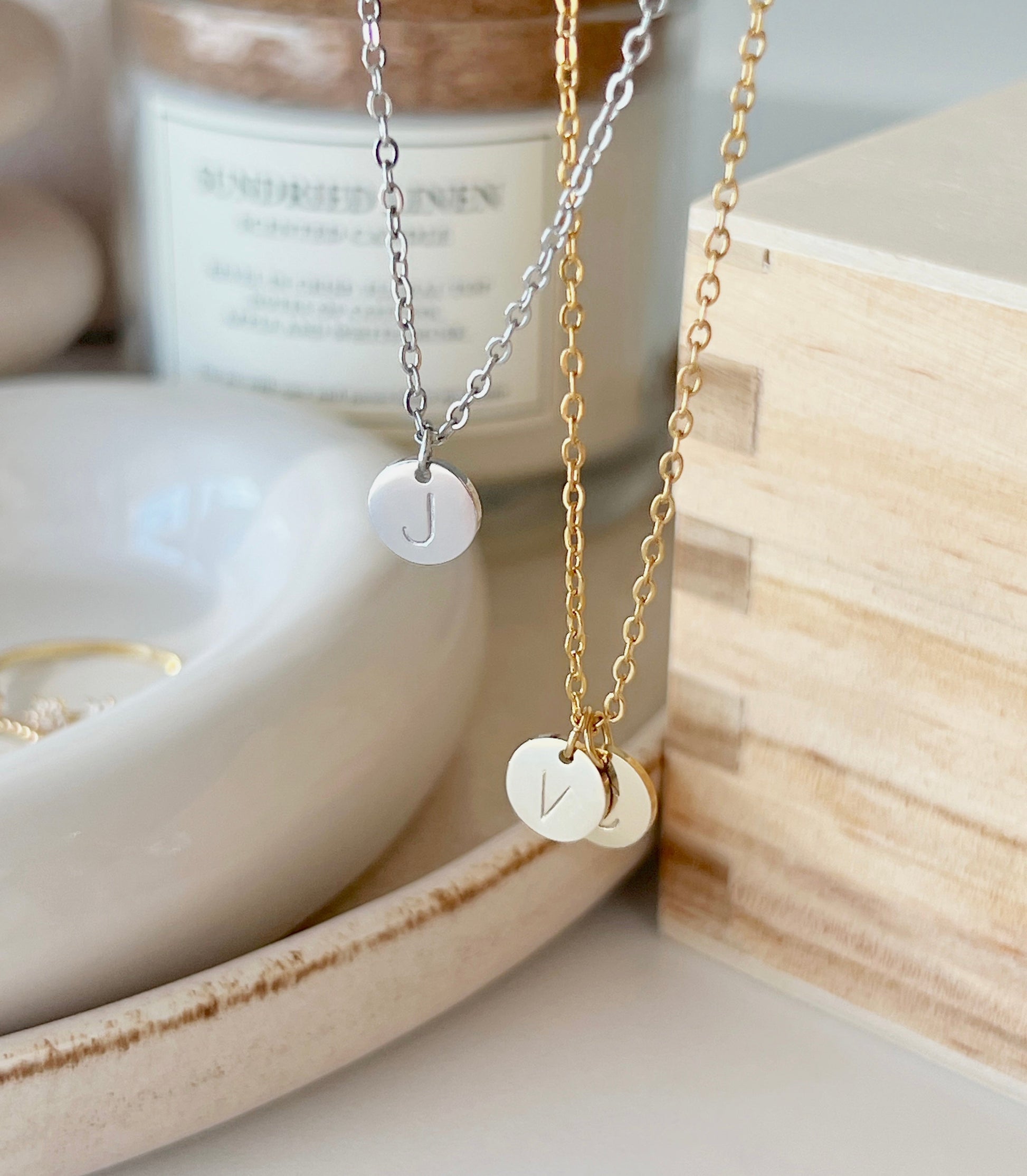 Product shoot of gold and silver initial coin pendant 