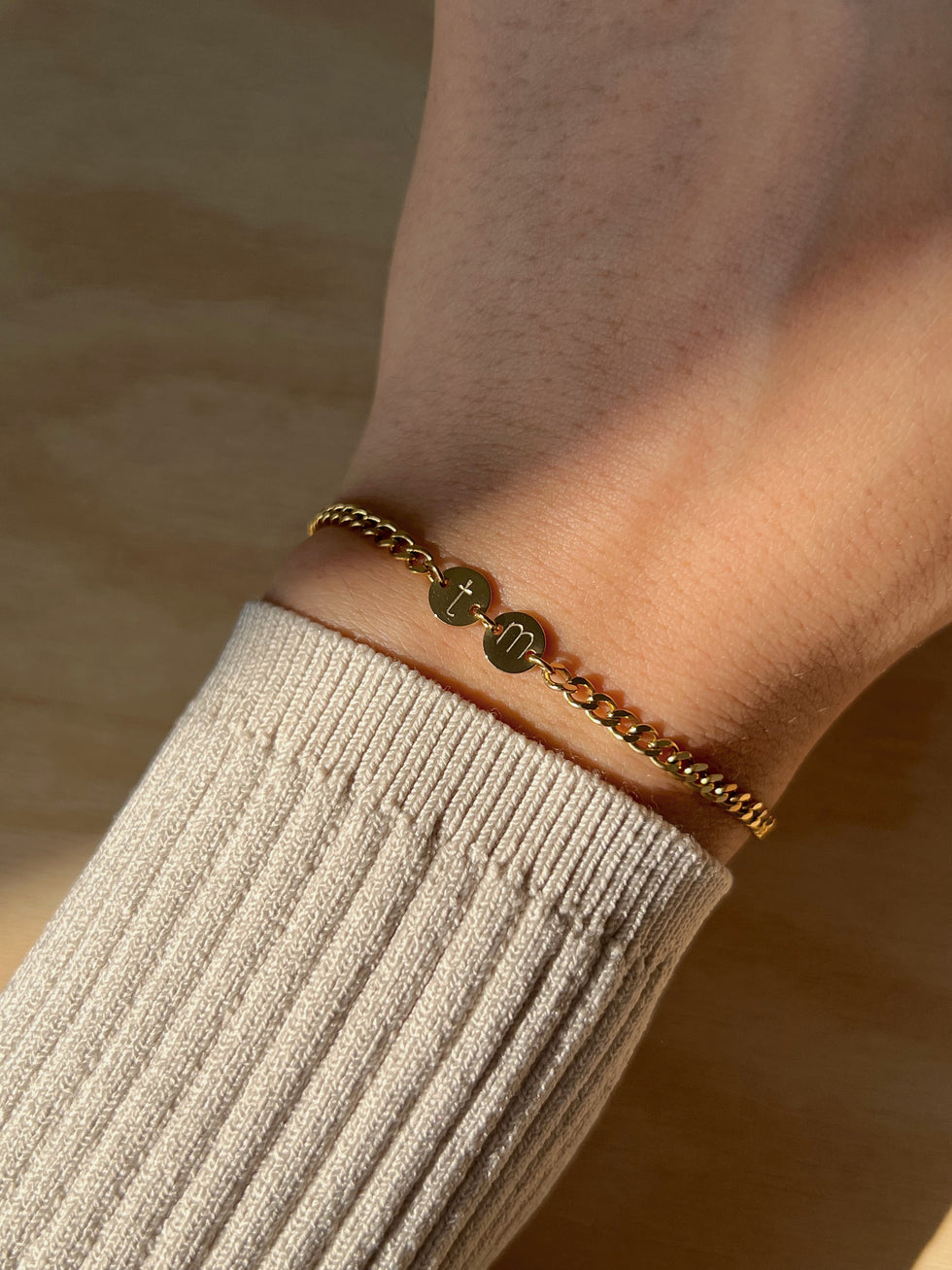 Girl wearing gold forever mine bracelet with initials 