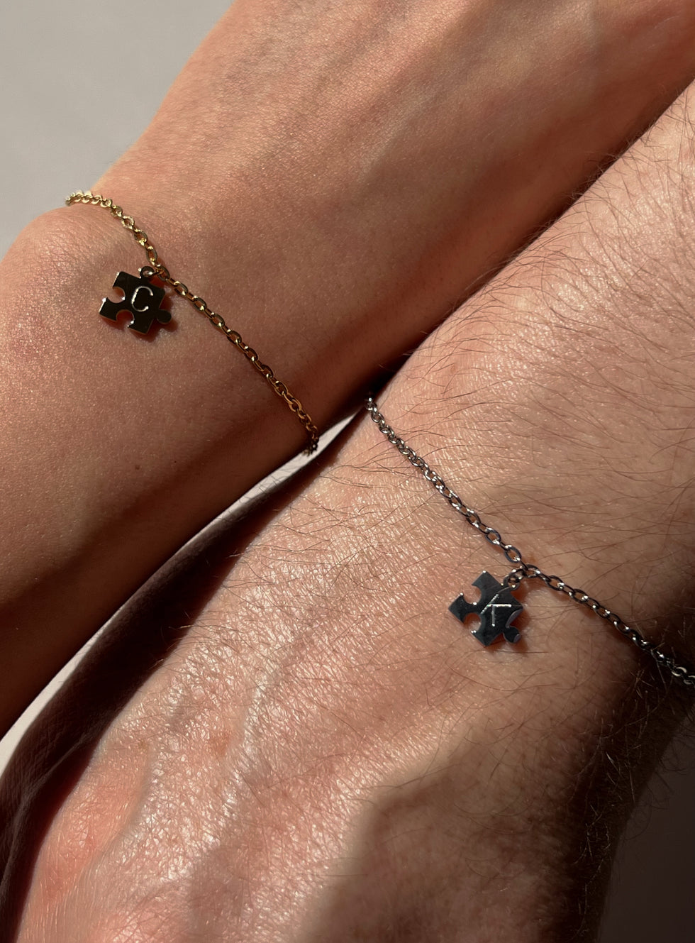 Couple wearing gold and silver initial bracelet 