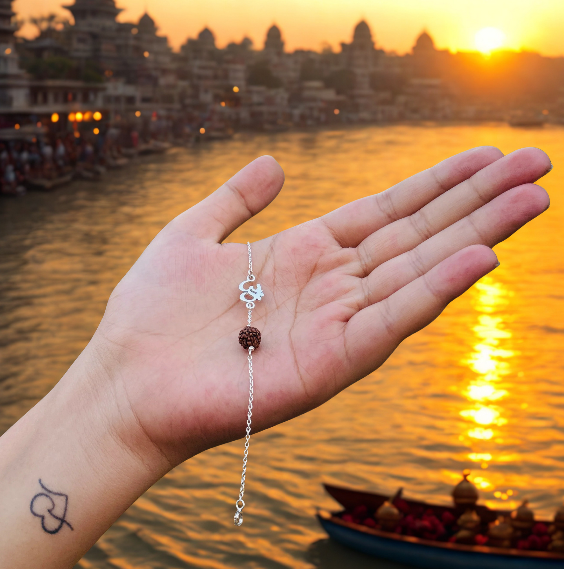 Om Rudraksha bracelet in model hand behind Ganga ghat