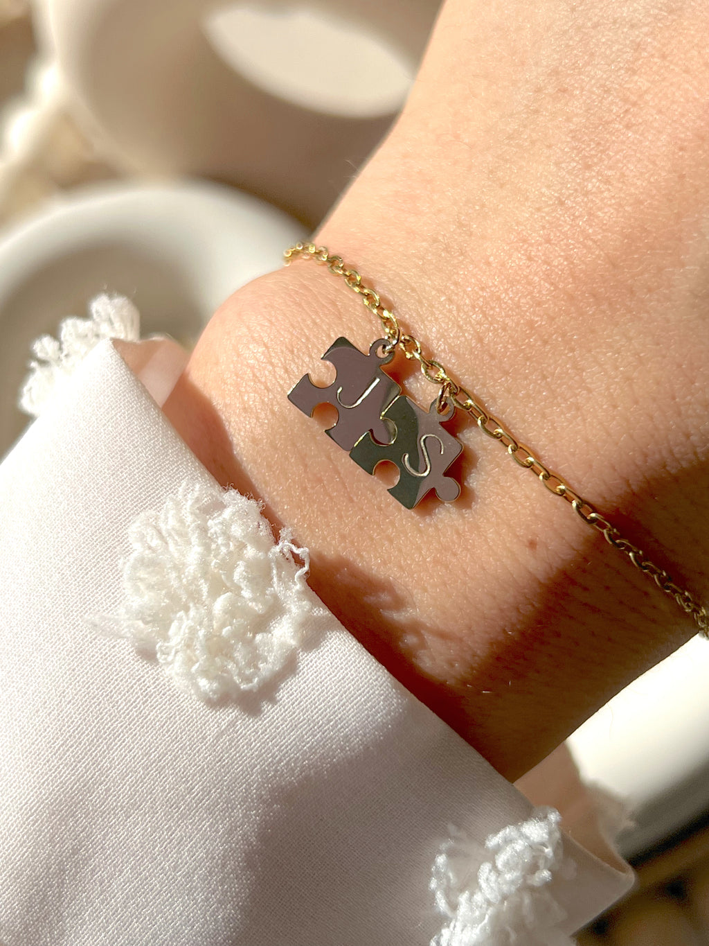Model wearing silver you complete me bracelet with silver initials 