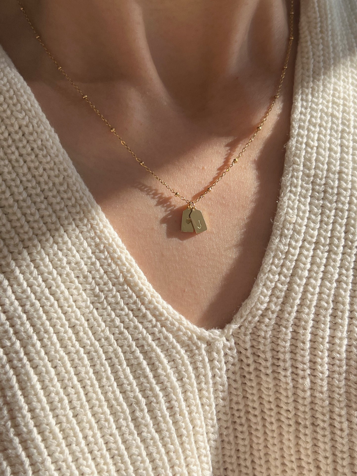 Model wearing heart & initial pendant 
