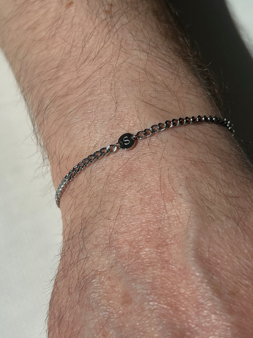 Boy wearing her initial forever mine bracelet 