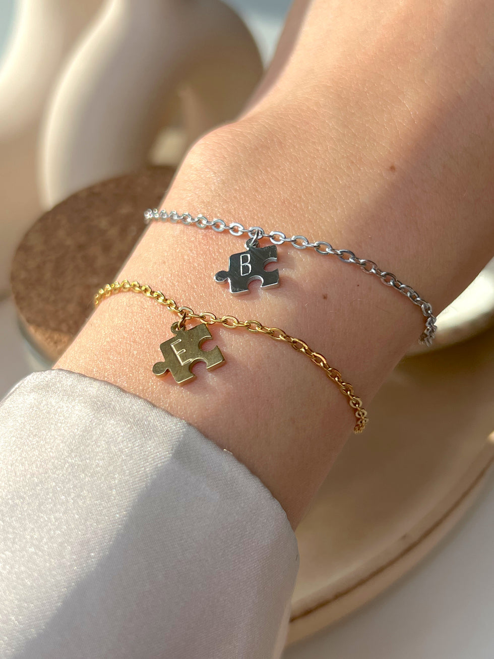 Model wearing his and her initial puzzle bracelet 