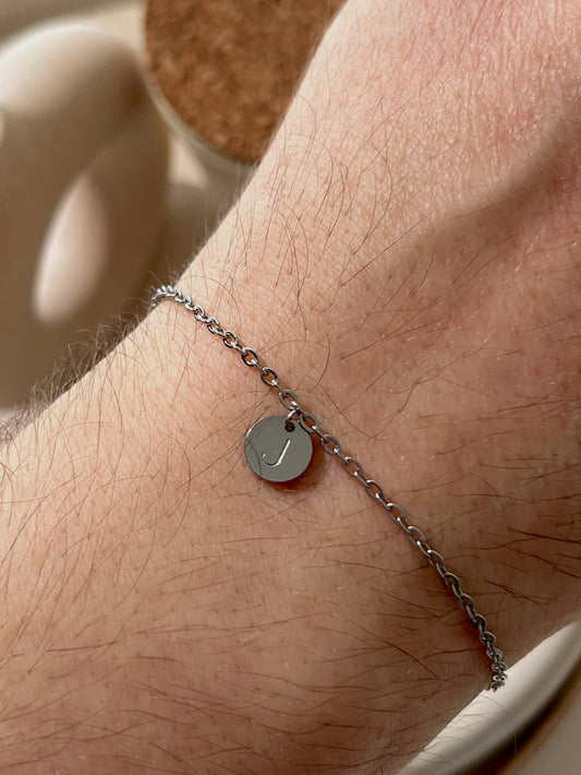 Men wearing silver initial coin bracelet 