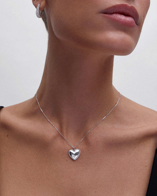 Model elegantly wearing Eraya Jewel's Noah's Heart Shape Necklace, a delicate sterling silver pendant perfect for everyday style