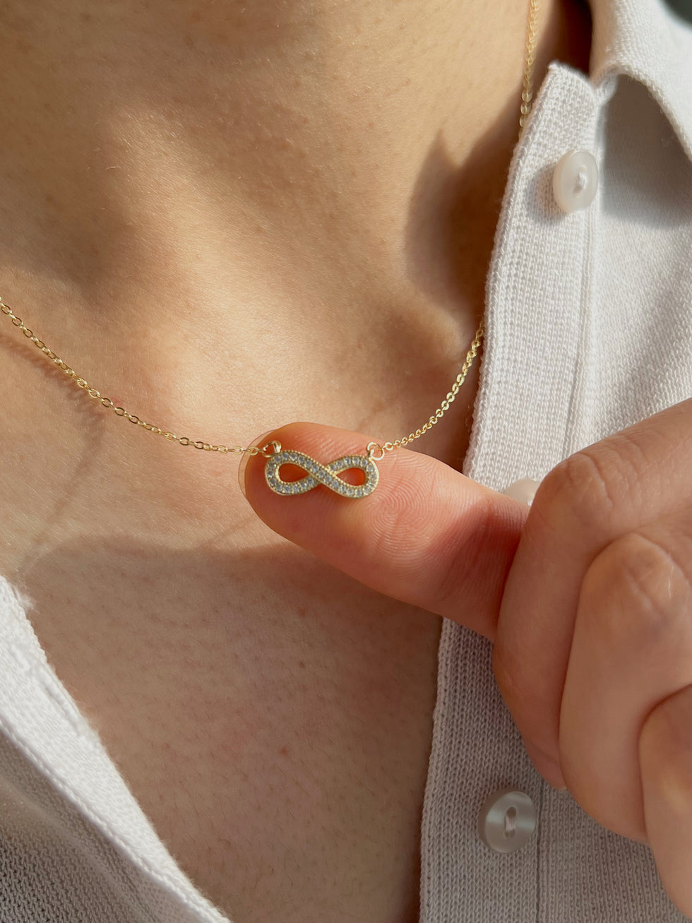 Minimalist infinity necklaces styled with cozy knit sweater