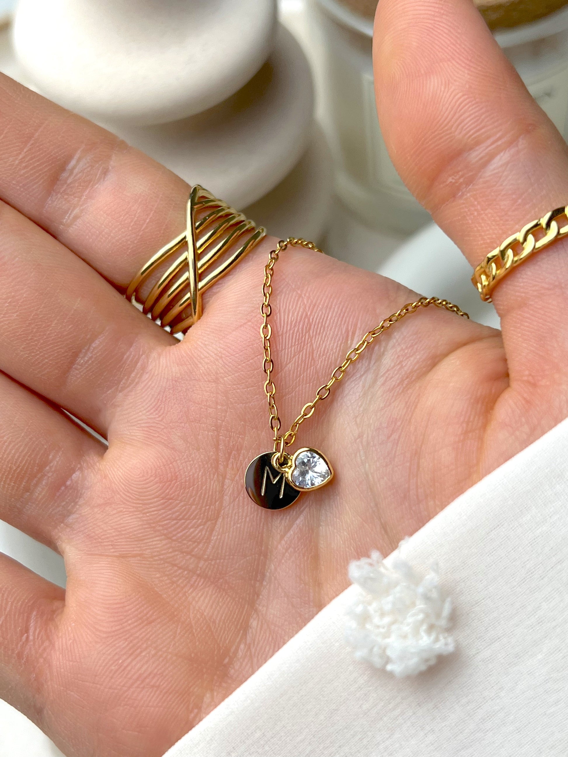 Silver polished initial pendant necklace with hidden engraving, styled for a minimal everyday look