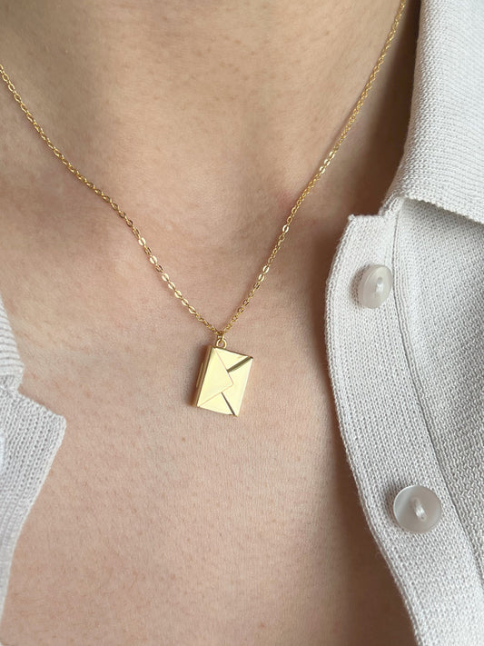 Model wearing gold polished envelope pendant with hidden love message zoomed photoshoot 