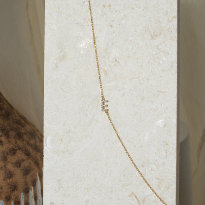Sideways pavé initial necklace featuring a sparkling CZ letter E pendant
