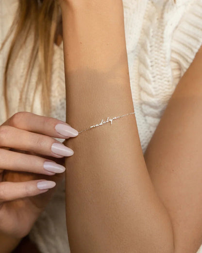 Woman showcasing her Eraya Jewel Dainty Name Bracelet in Silver, a perfect subtle personalized accessory for everyday wear