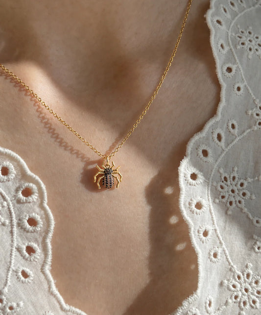 Edgy aesthetic spider necklace for women featuring 18k gold plating and sparkling zircon diamonds.