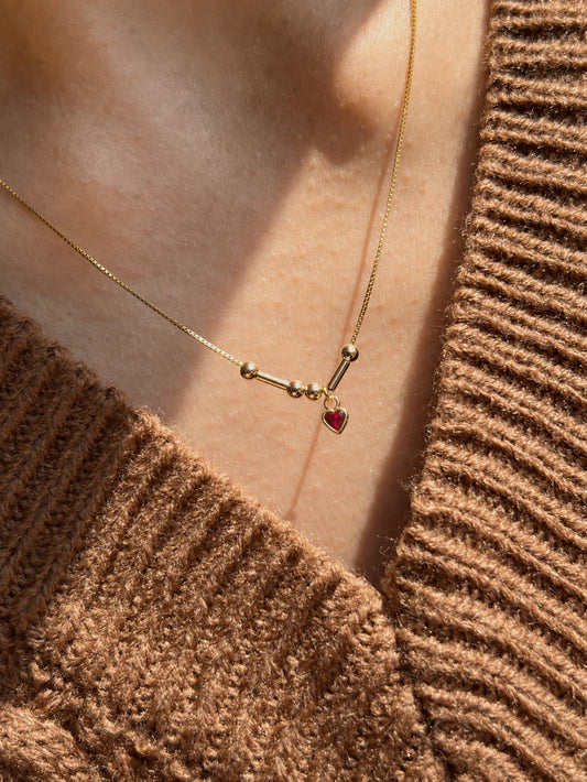 Tiny Heart Morse Code Initials Necklace in 22 karat gold finish worn by model featuring personalized Morse code design with tiny heart stone charm